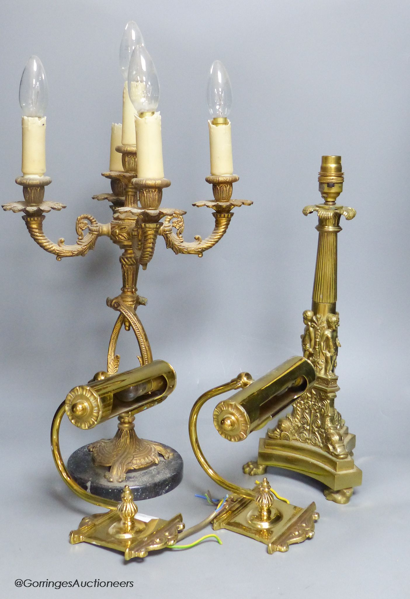 A figural cast brass table lamp, a pair of Art Deco wall lamps, a 3 branch wall light and a five branch electrolier